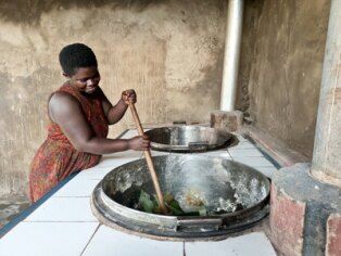 world food day woman stirring pot.jfif